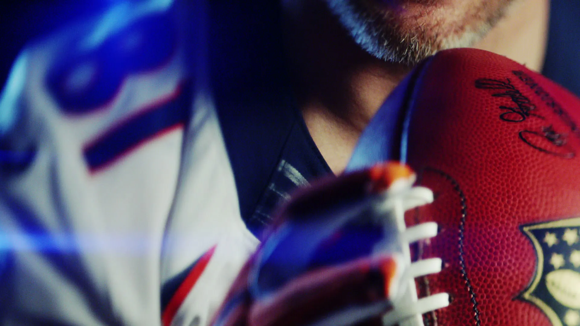 Player in uniform in dramatic low-key light — Super Bowl 50 tease